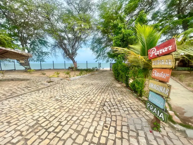 Entrada com placa decorativa da Pousada do Farol